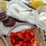 strawberries, mint cookies and sugar bowl on table