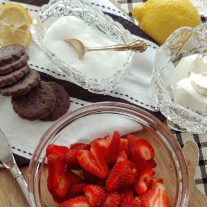 strawberries, mint cookies and sugar bowl on table