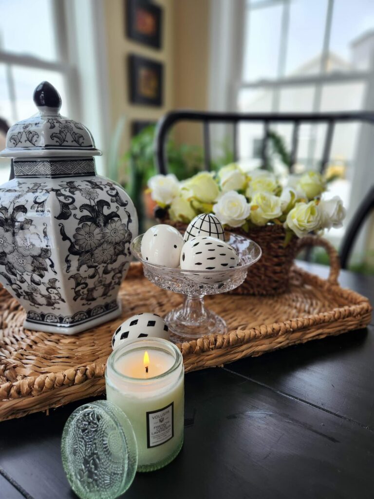 black and white ginger jar on wicker tray on table
