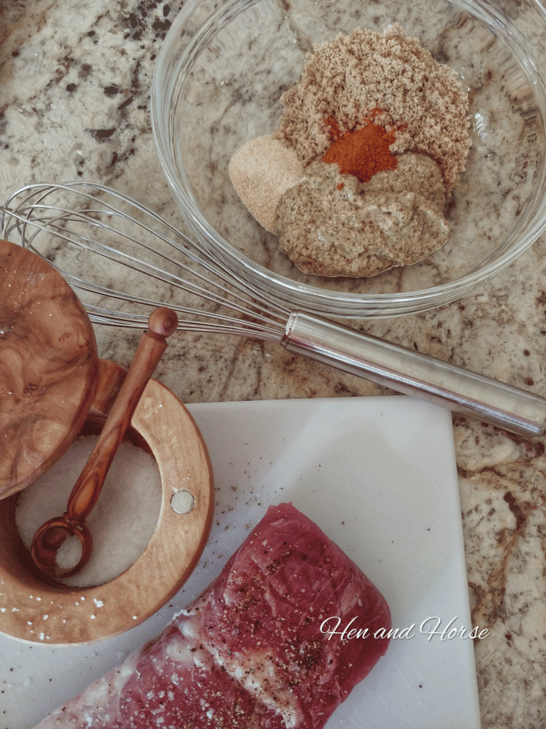 overhead viewe of pork tenderloin and mustard dressing for baking