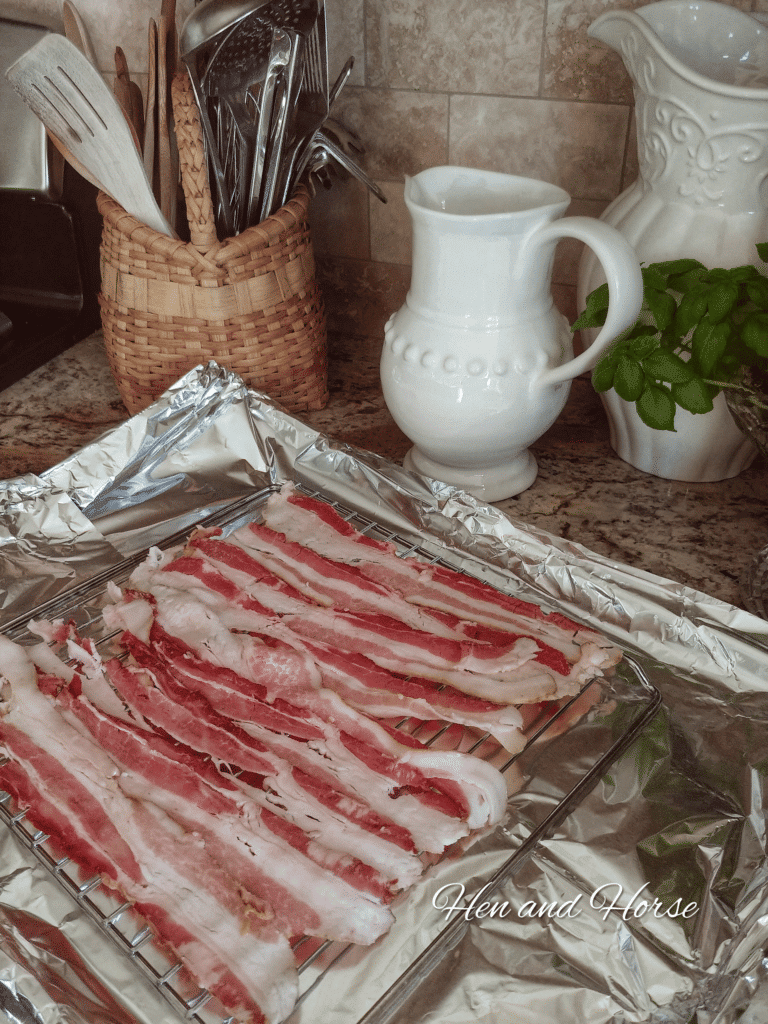  bacon on oven rack which is placed on a baking tray lined with tin foil