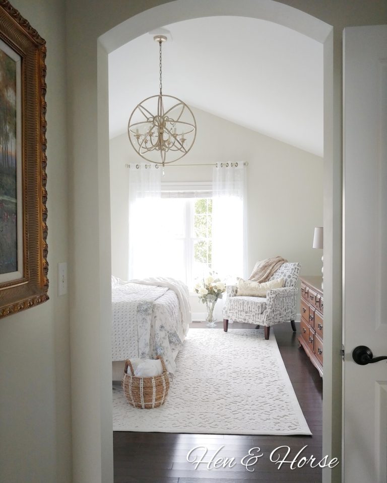 A bedroom with a chandelier