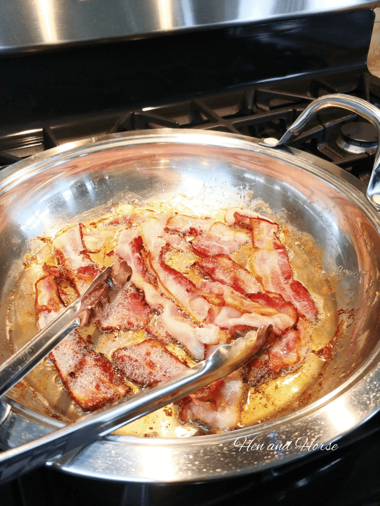 bacon on top of a metal pan on a stove