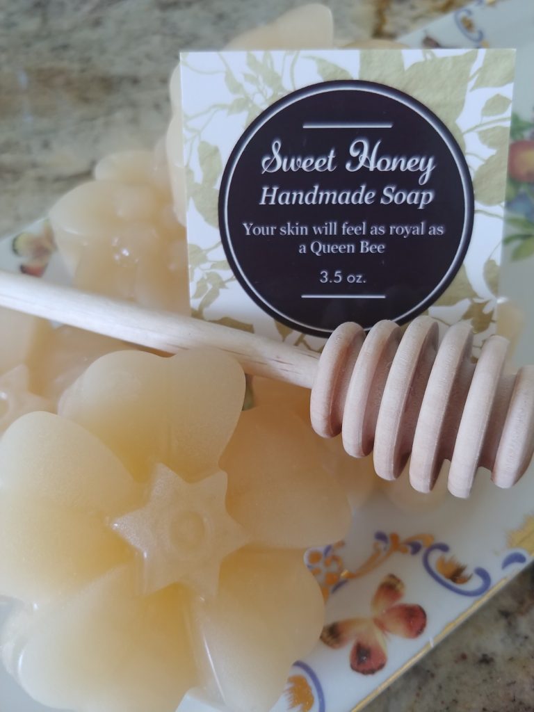 beeswax soap with a honey dipper next to it