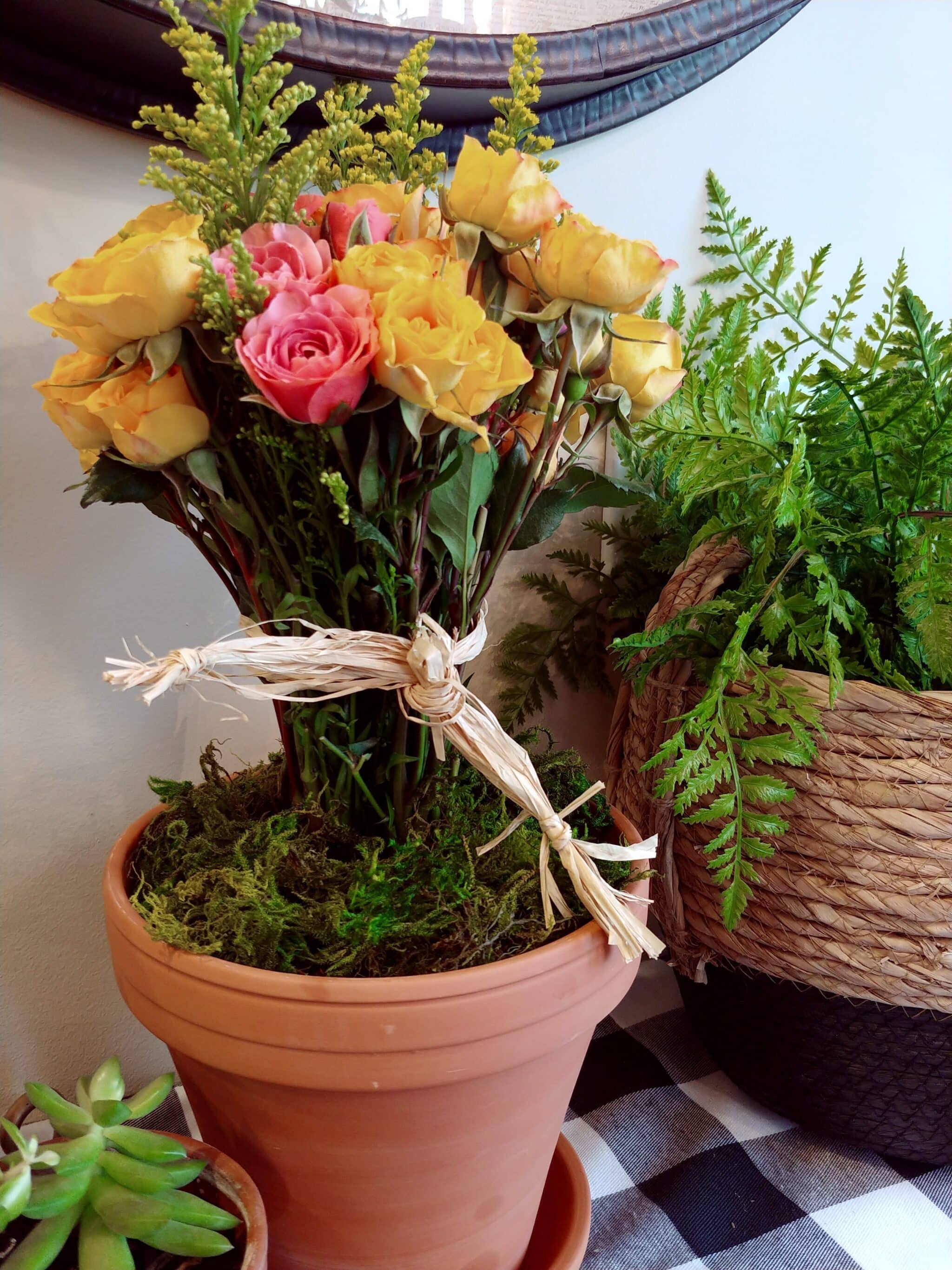yellow and rose flower topiary in pot