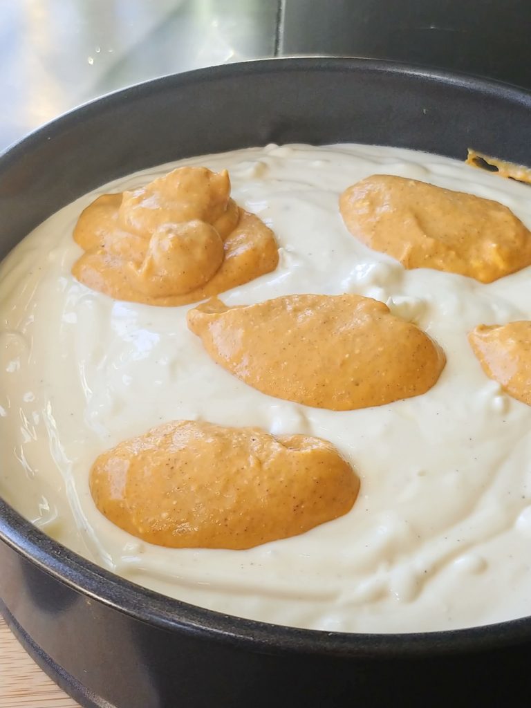 dollops of pumpkin mixer being added to baking pan