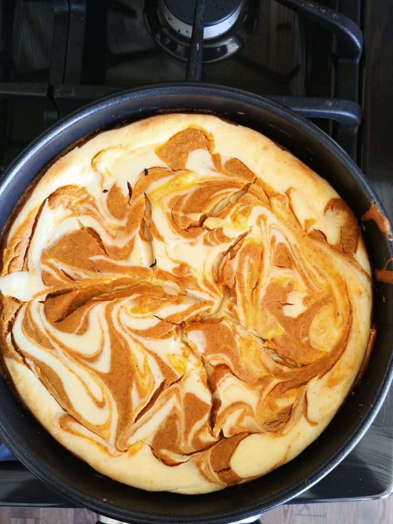 baked pumpkin swirl cheesecake in pan