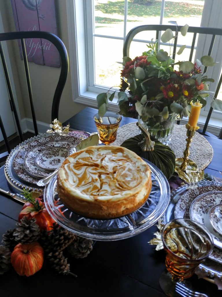 pumpkin swirl cheesecake on pedestal dish