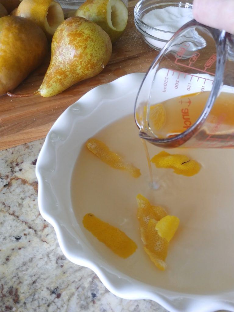 pouring brandy into a baking dish