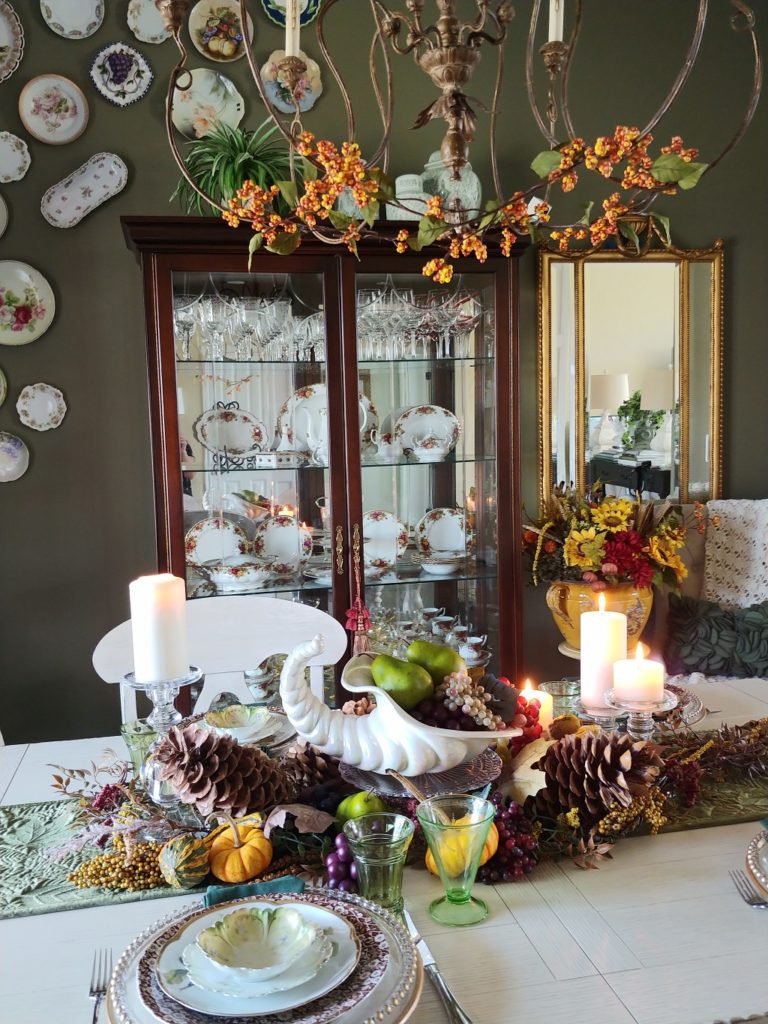 fall table with cornucopia and pumpkins