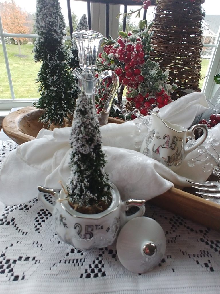 a bottle brush tree in a vintage creamer cup