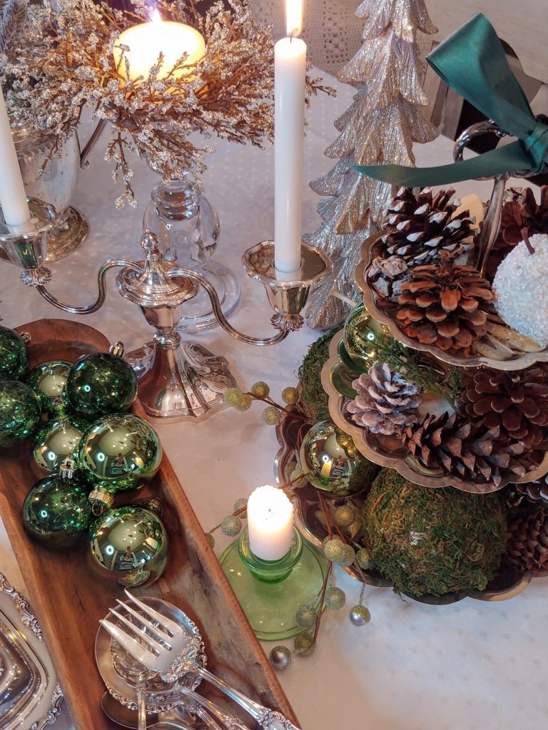 a tiered tray with pinecones in it