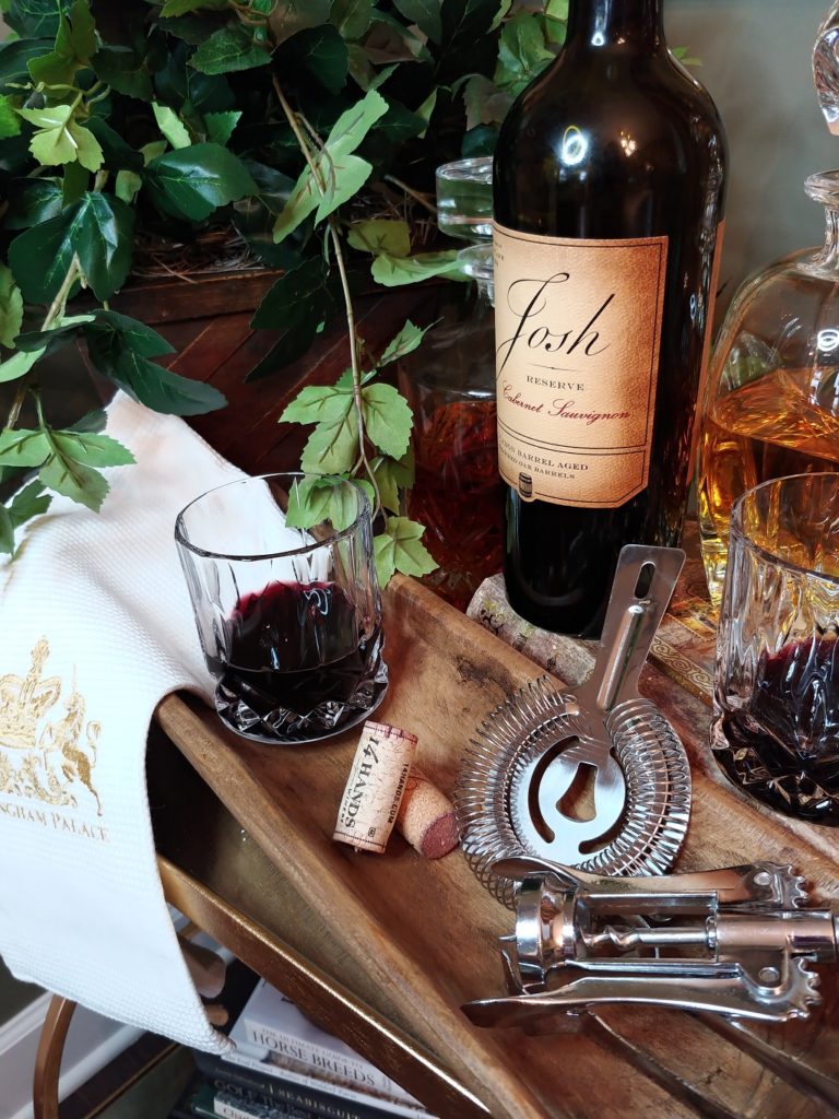 A table with wine glasses, with Bottle