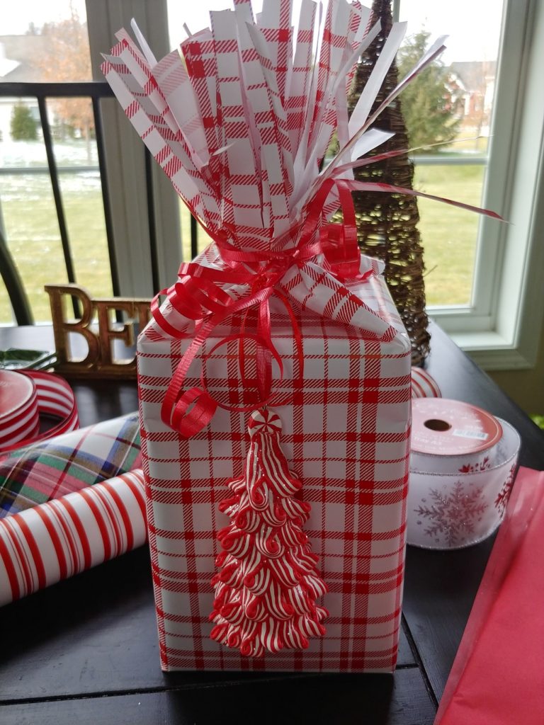 christmas present wrapped in red and white paper