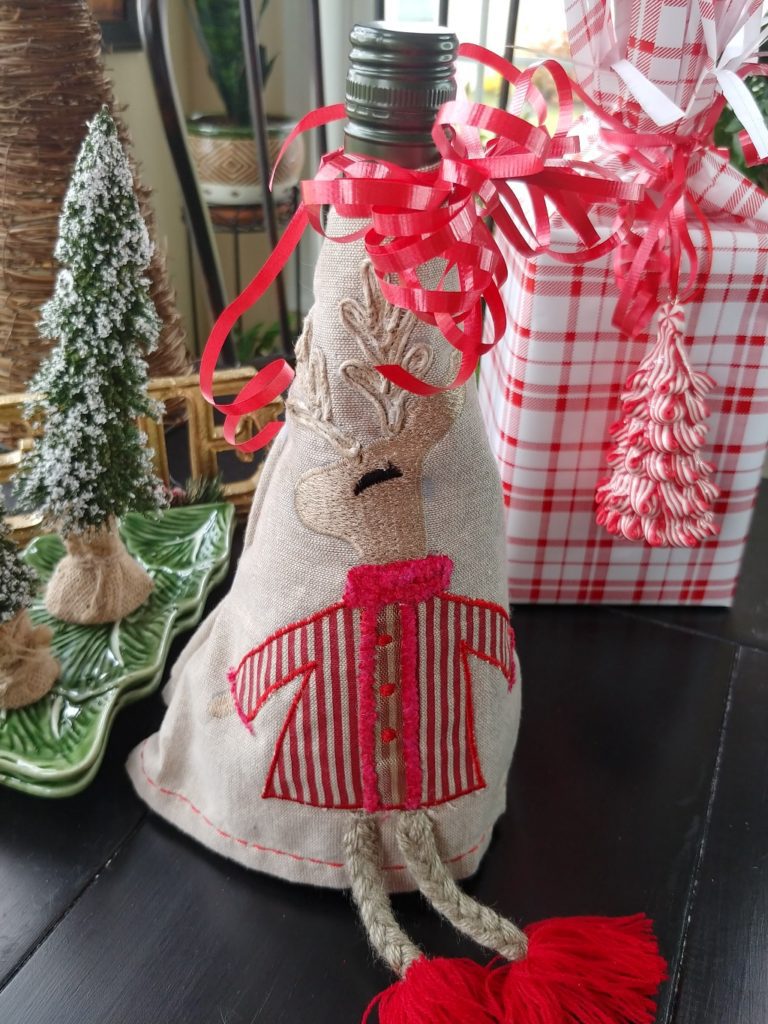 reindeer dish towel wrapped around a wine bottle