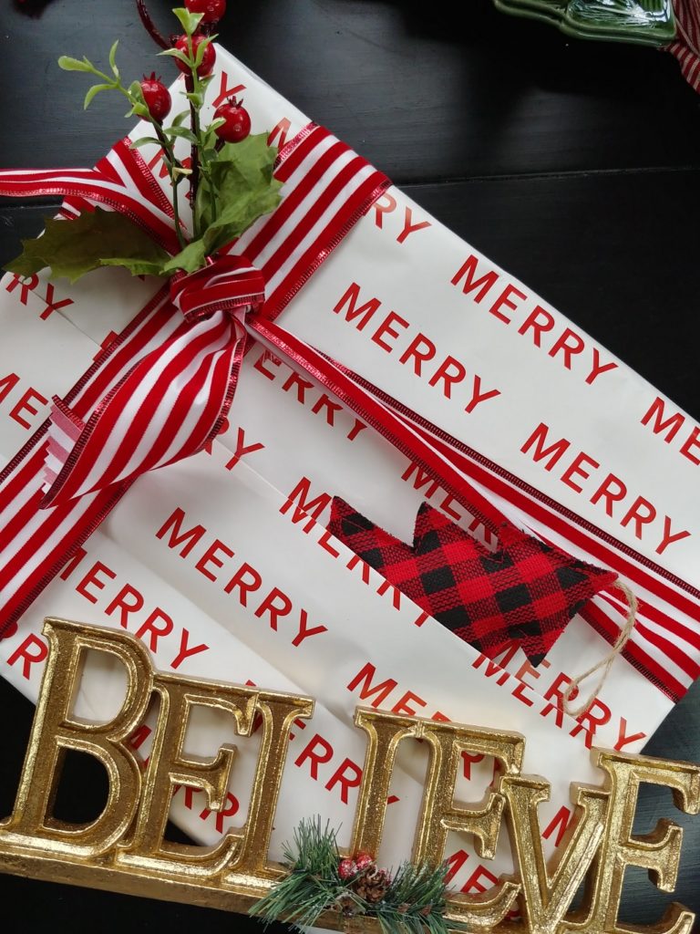 present wrapped with christmas paper with merry written on it