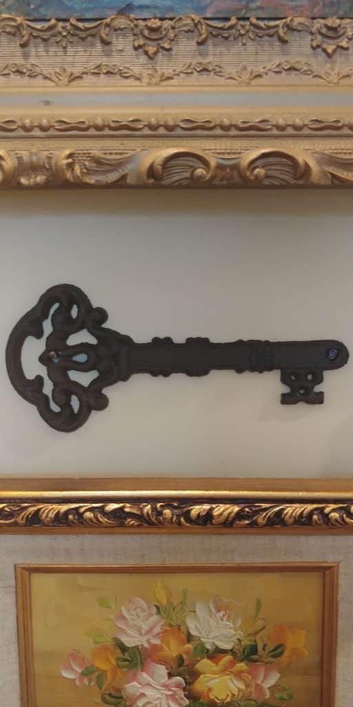wrought iron key hanging on wall