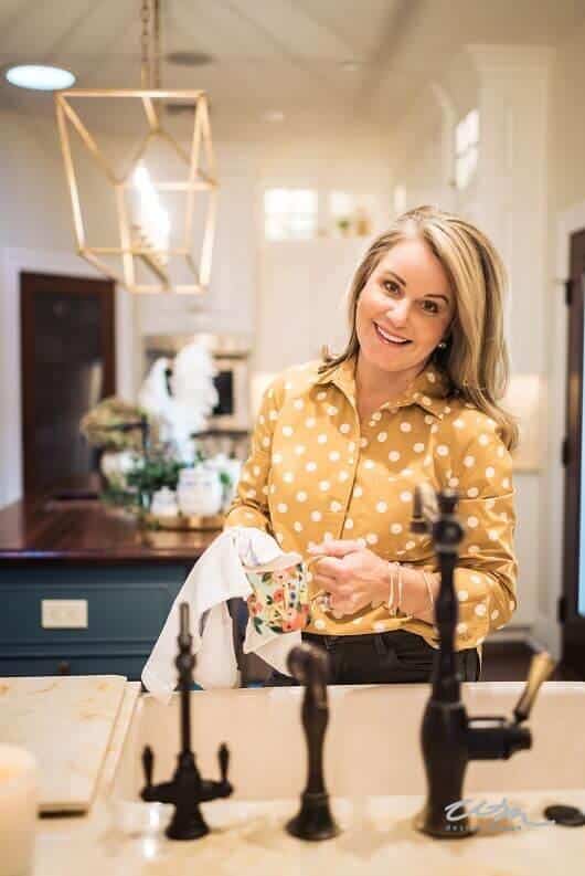 A woman standing by kitchen sink