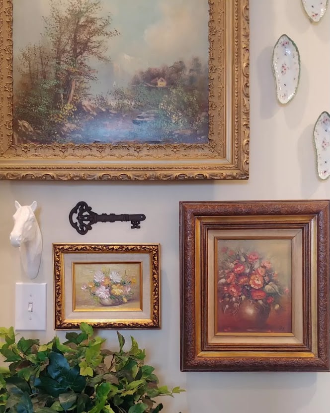 a close up of a gallery wall and paintings