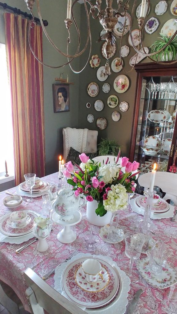 A vase of pink flowers on a table