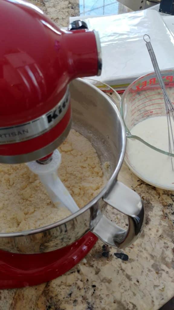 A bowl of ingredients in a mixer on a table