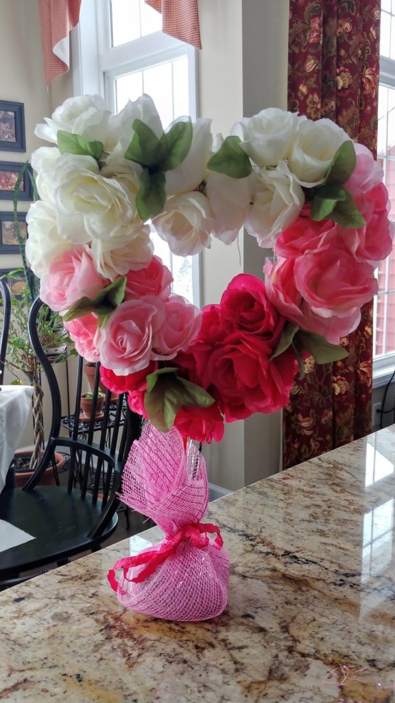 A vase filled with pink flowers on a table
