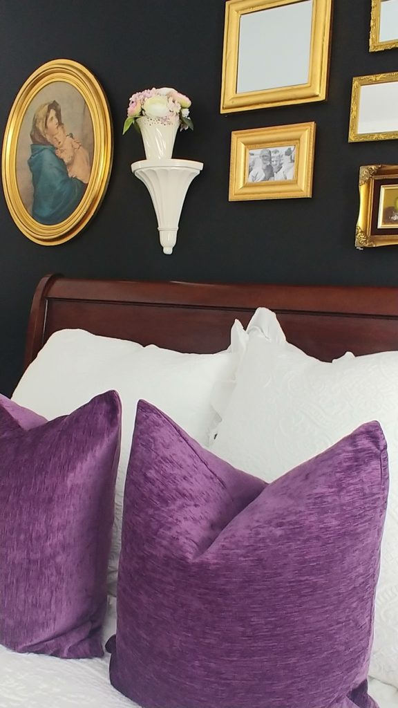 A bed with a purple pillows