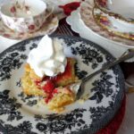 cherry tart on dish with whipped topping