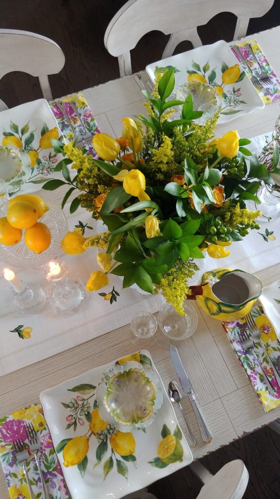 A vase of yellow flowers on a table