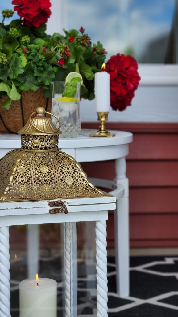 White table with flowers, lantern and candle on it