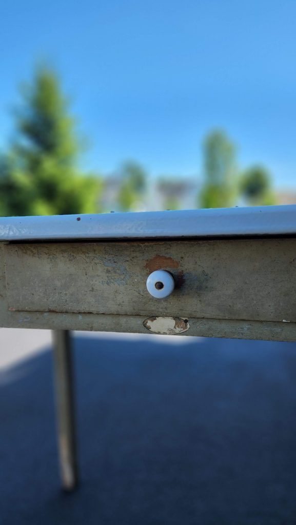 upclose of wooden table drawer with knob