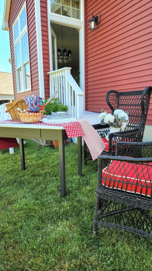 old table with wicker chair on grass
