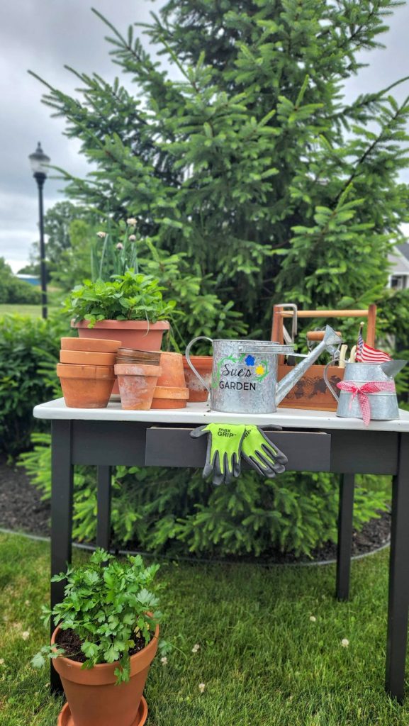 Potting table with terra cotta pots on it