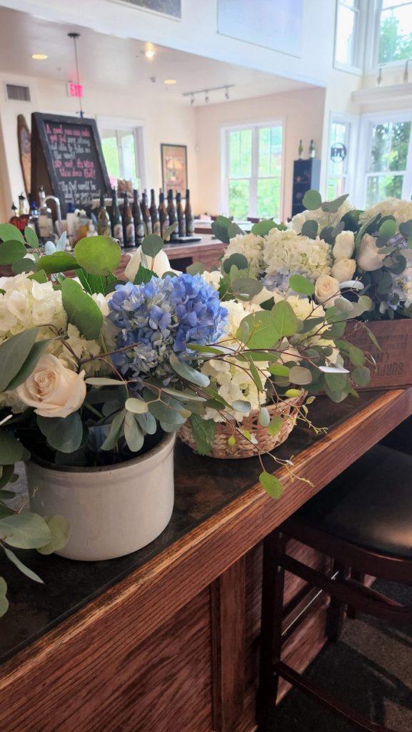 blue & white flowers in various vessels