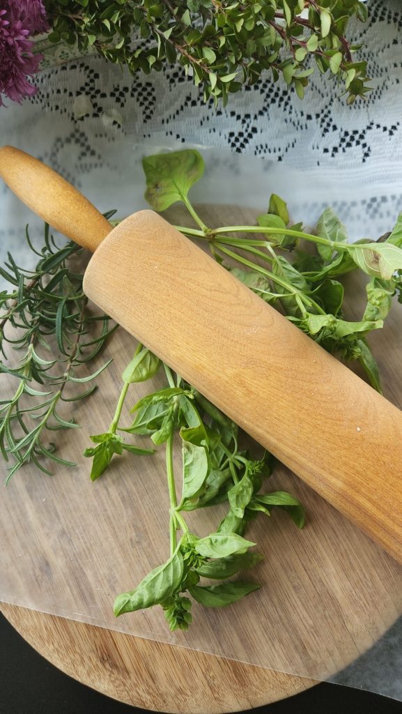 Fresh Herbs & rolling pin on table