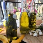 bottles of olive oil with herbs inside