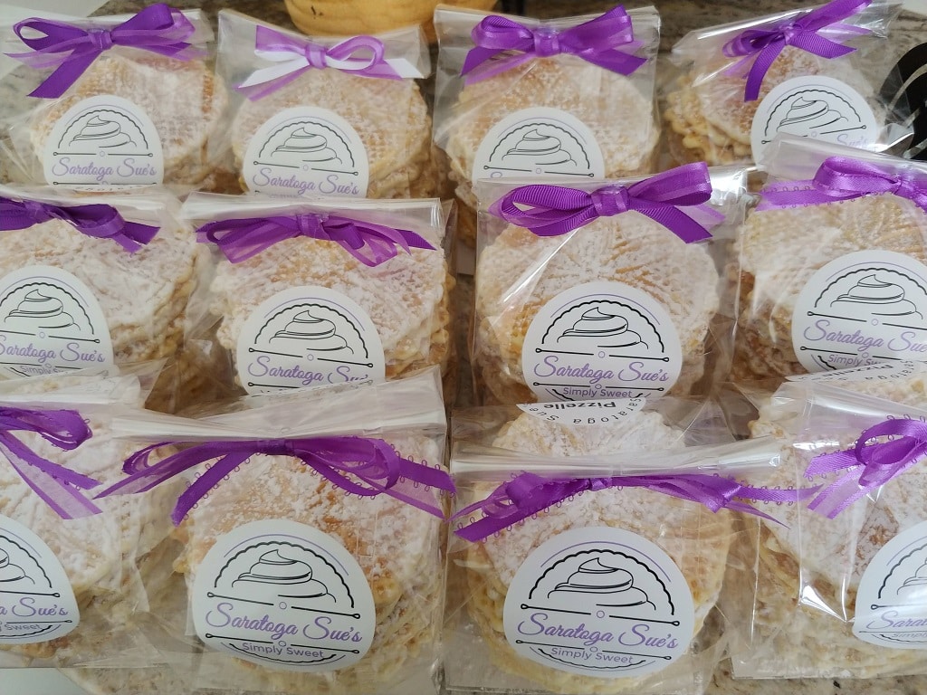 bags of pizzelle cookies with purple bows on them