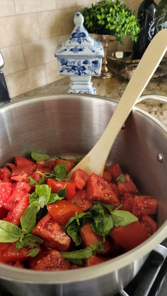 cut fresh tomatoes with herbs on top