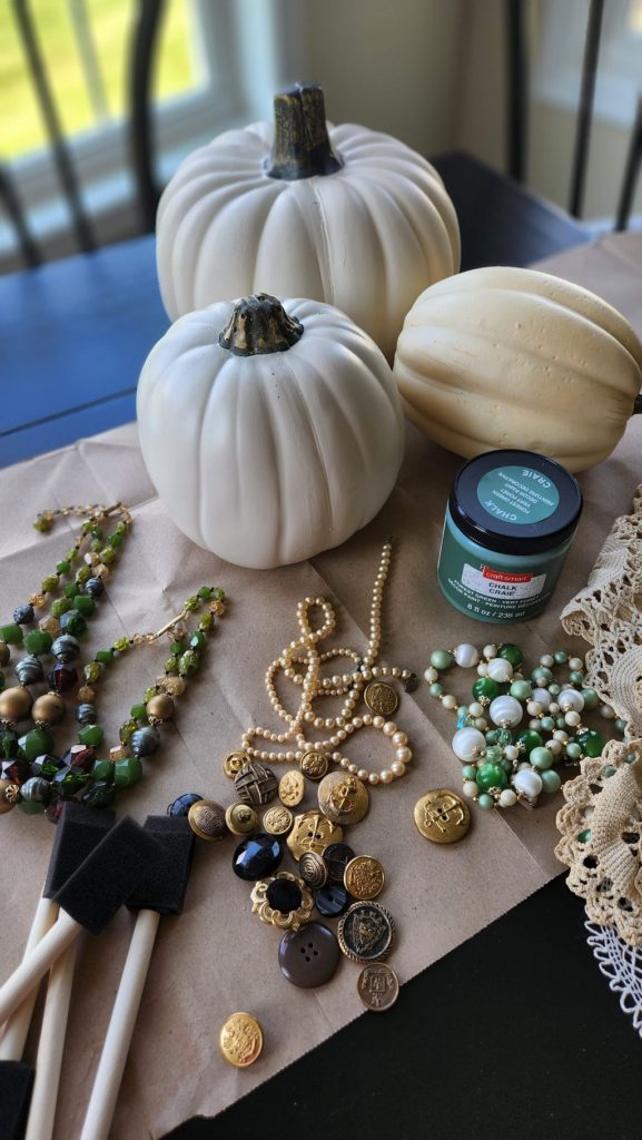 pumpkins and jewlery on table to decorate the pumpkin