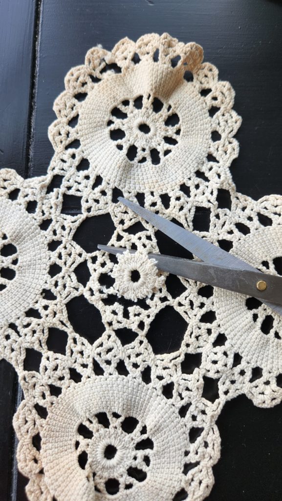 scissors ready to cut center of lace doilie