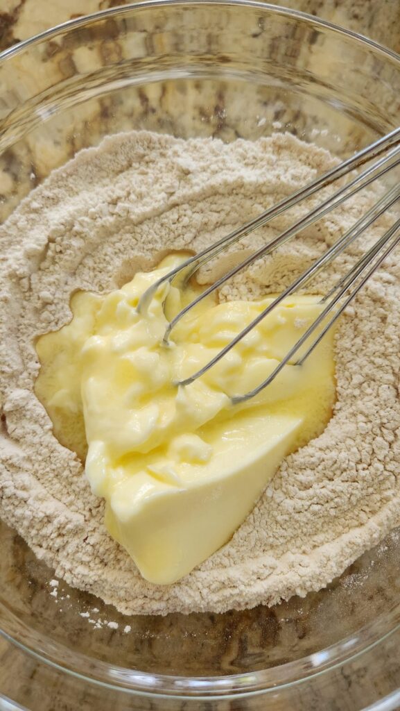 glass bowl with flour and melting butter in middle