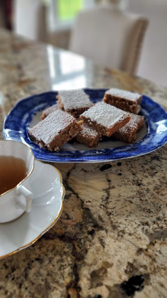 cappuccino squares on blue dish with white teacup