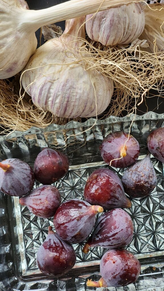 garlic and figs in glass dish