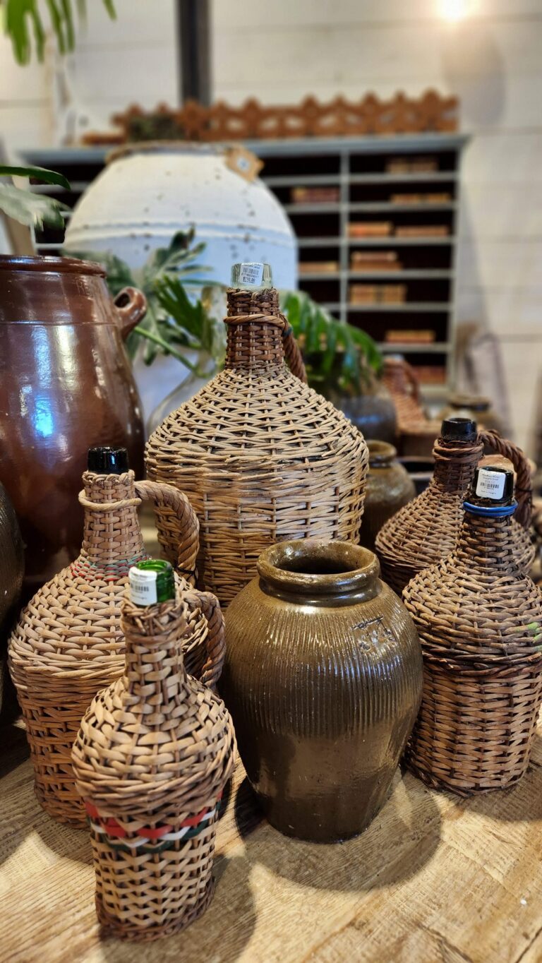 brown pottery and wicker jugs on table