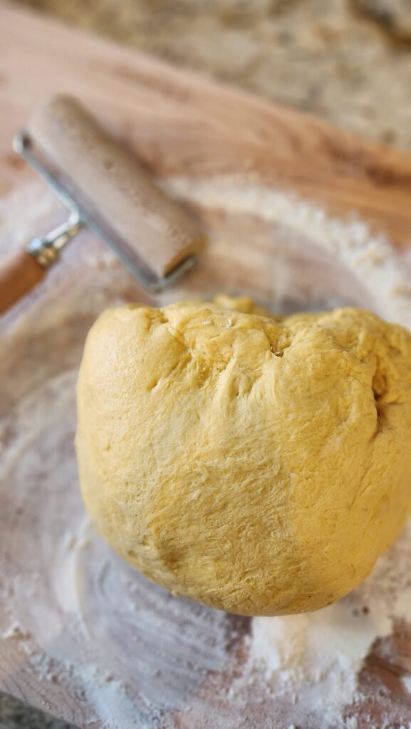 pumpkin bun dough on floured board