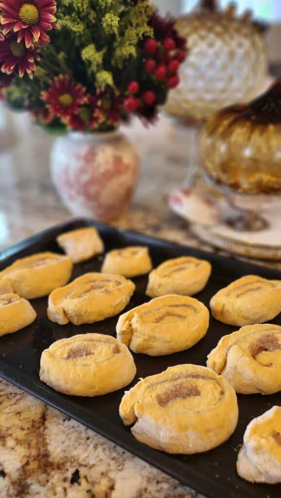 pumpkin buns on baking pan ready for oven