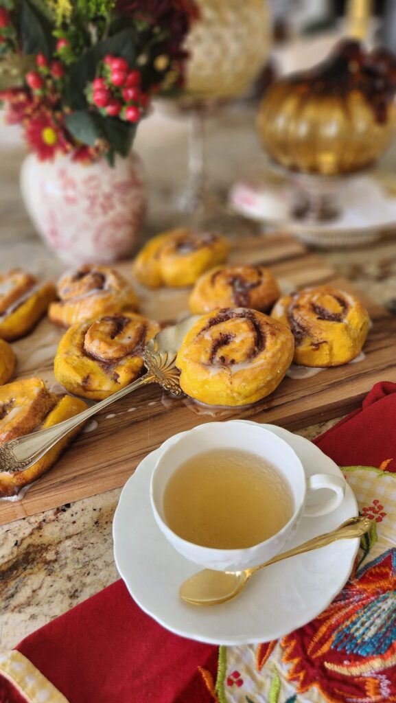 pumpkin buns with white teacup on counter