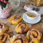 pumpkin bums on counter along side a white tea cup