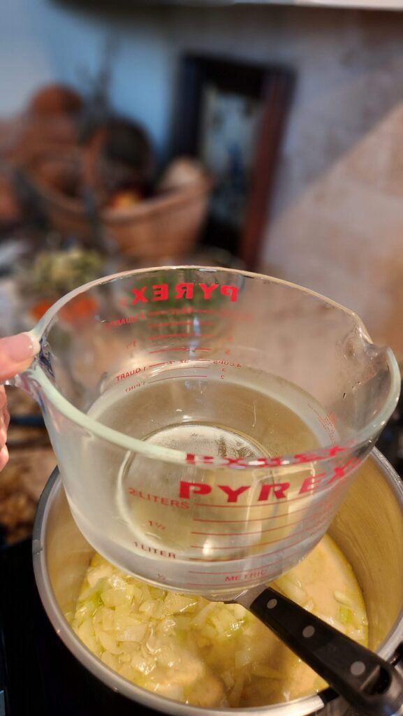 4 cups of water ready to pour into pot for soup