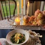dinner table with candles and minestrone soup bowl